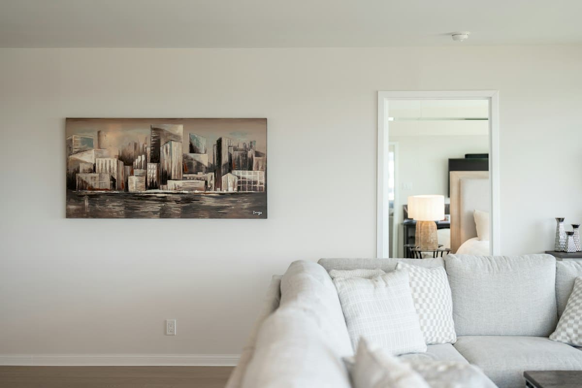 Cityscape painting in a light, minimal living room